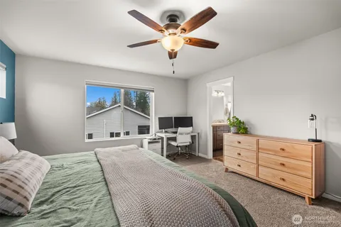 a bedroom with a large bed and a chandelier