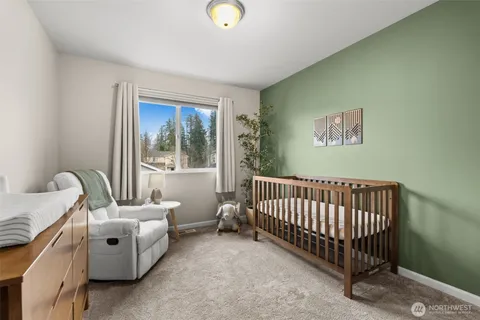 a spacious bedroom with a bed and a window