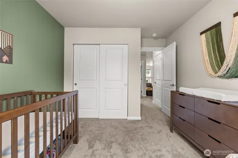 a view of hallway with mirror and furniture