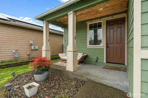 a view of a house with chair and potted plants