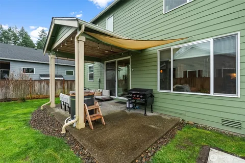 a view of a house with backyard sitting area and garden