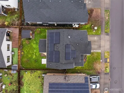 an aerial view of a house with a yard
