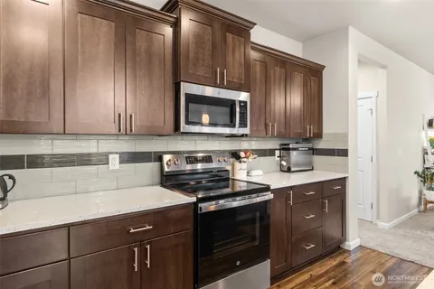 a kitchen with sink cabinets and stainless steel appliances