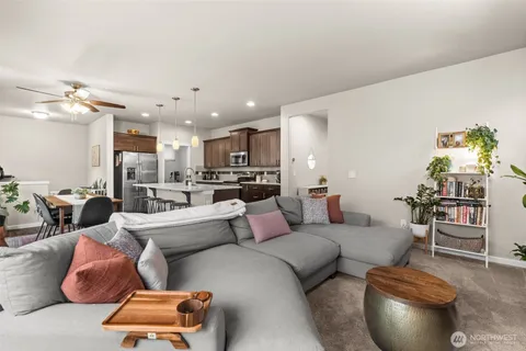 a living room with furniture and kitchen view