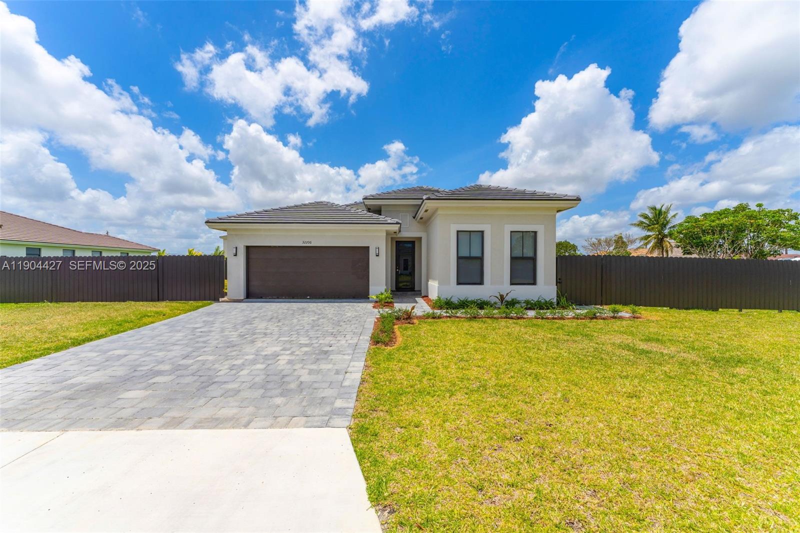 32206 Southwest 196th Avenue, Unit 1 Homestead, FL 33030 - Photo 1 of 8 a view of a house with a backyard
