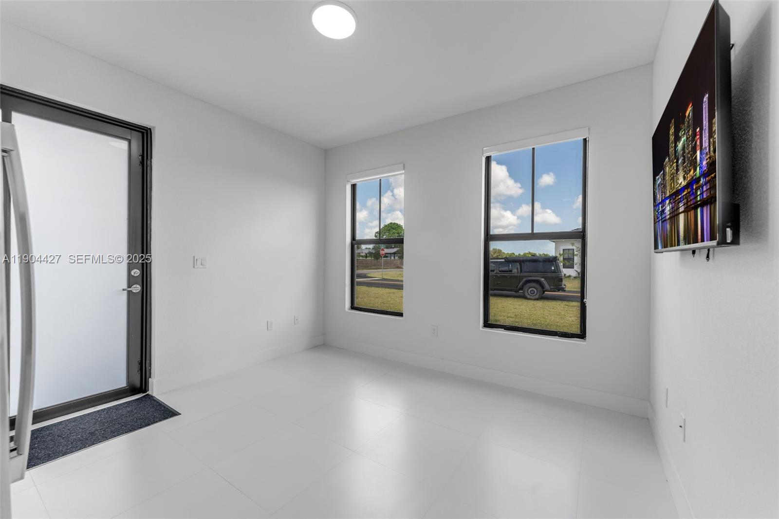 32206 Southwest 196th Avenue, Unit 1 Homestead, FL 33030 - Photo 2 of 8 an empty room with windows and closet