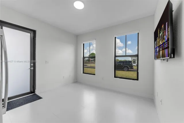 an empty room with windows and closet