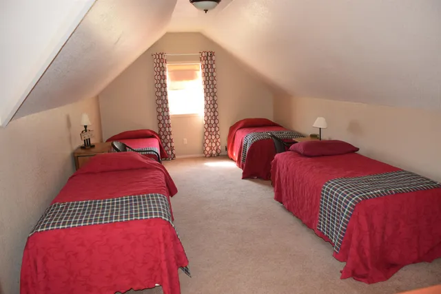 a bedroom with two beds and a window