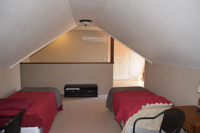 a bedroom with a bed and a potted plant