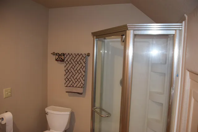 a bathroom with a toilet and a shower