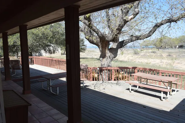 a view of a balcony with chairs and wooden floor
