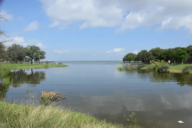 a view of a lake with houses in the back