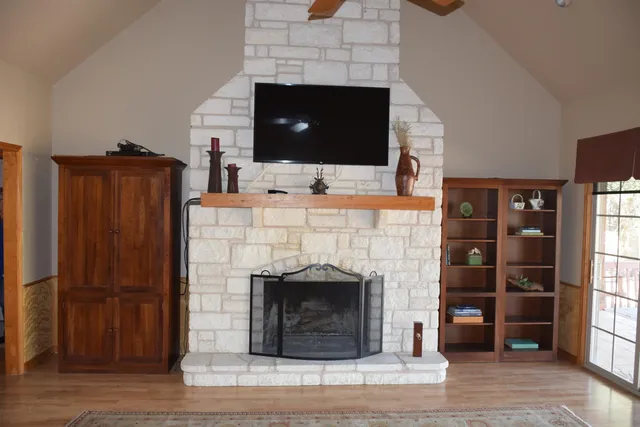 a living room with furniture a fireplace and a flat screen tv