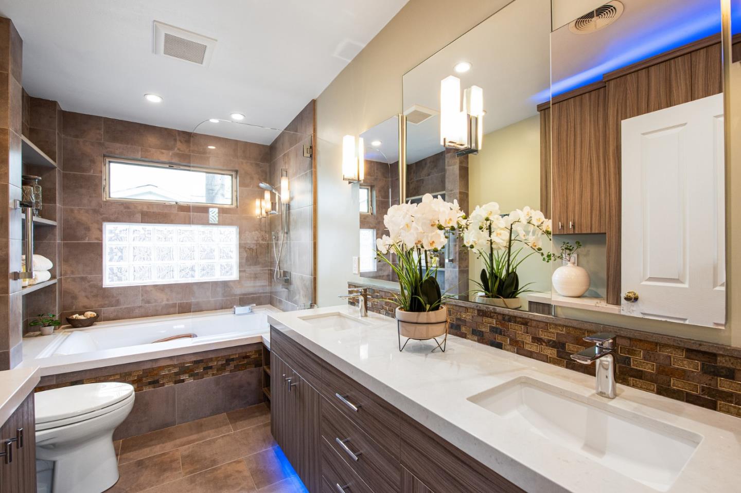 222 North 3rd Street Campbell, CA 95008 - Photo 13 of 35 a bathroom with double vanity sinks a large mirror and a bathtub