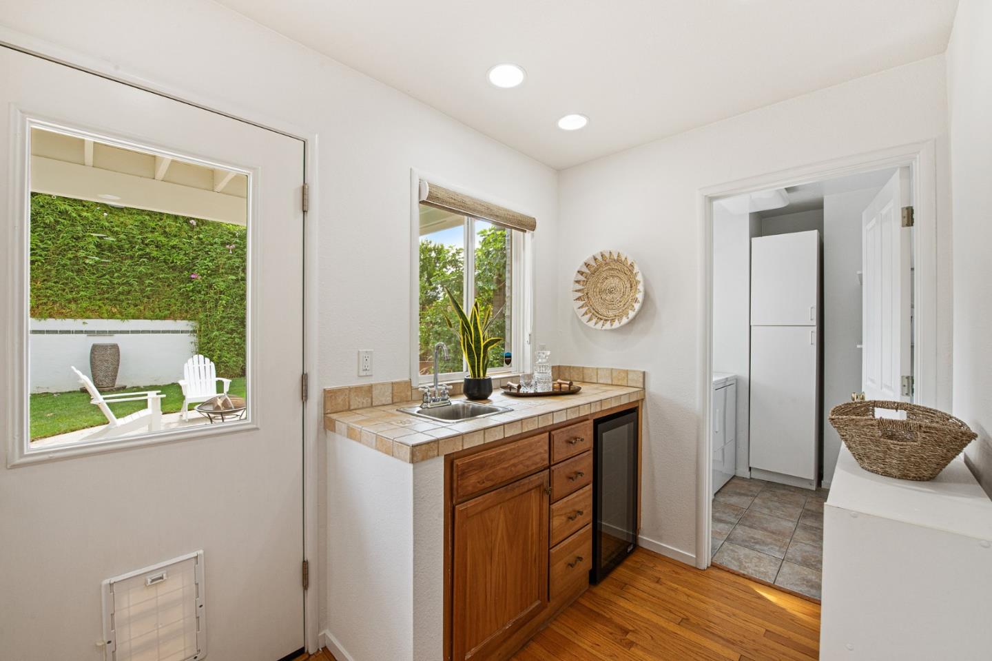 222 North 3rd Street Campbell, CA 95008 - Photo 21 of 35 a kitchen with a stove a sink a window and a refrigerator