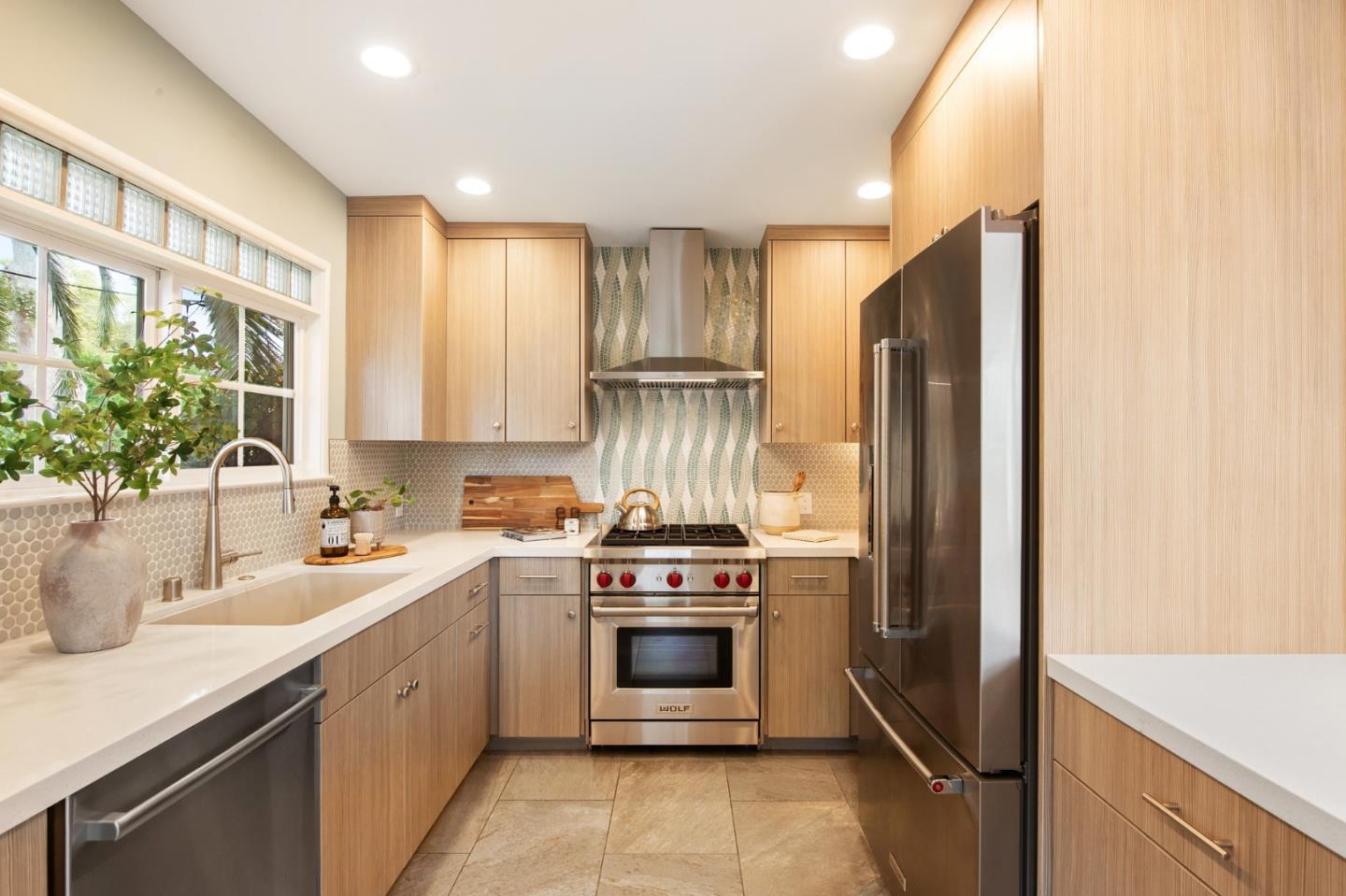 222 North 3rd Street Campbell, CA 95008 - Photo 8 of 35 a kitchen with a stove a sink and a refrigerator