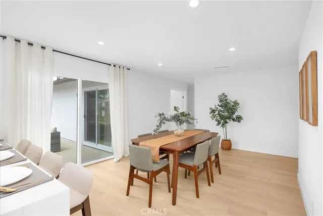 a dining room with furniture and wooden floor