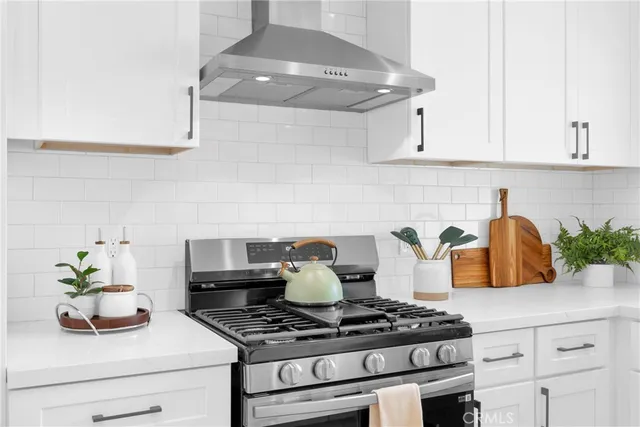 a kitchen with a stove and cabinets