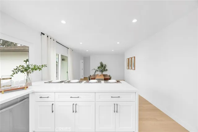 a view living room with granite countertop white cabinets and a potted plant