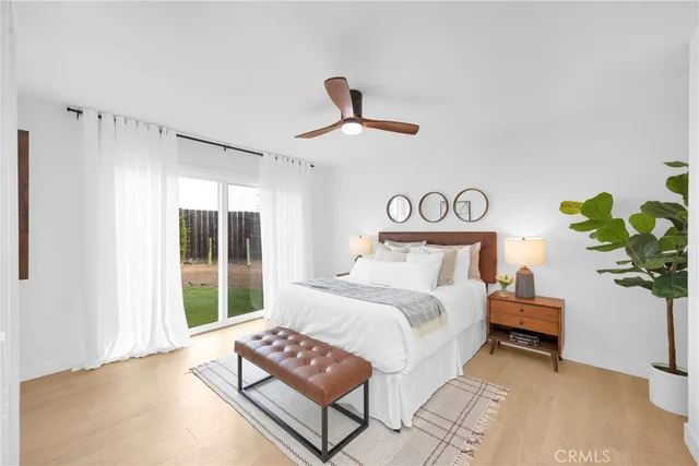 a bedroom with a bed a chandelier and a window