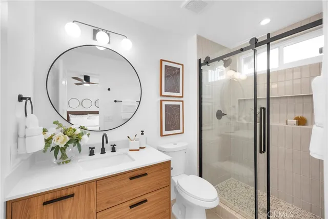 a bathroom with a toilet a sink and a mirror