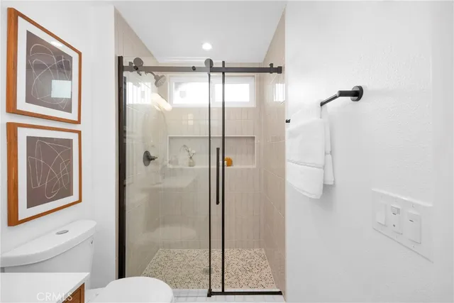 a bathroom with a shower and toilet