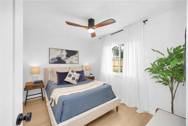 a bedroom with a bed and a potted plant