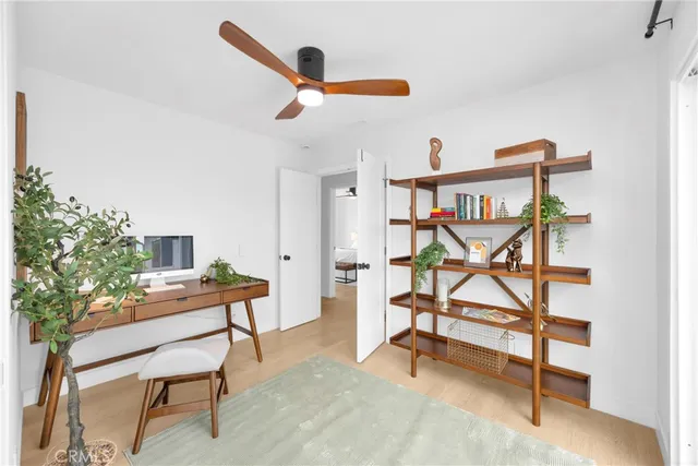 a reading room with furniture and a wooden floor