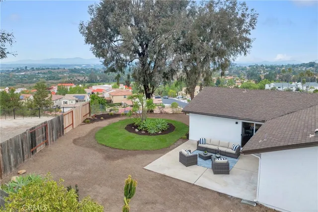 a backyard of a house with yard and outdoor seating