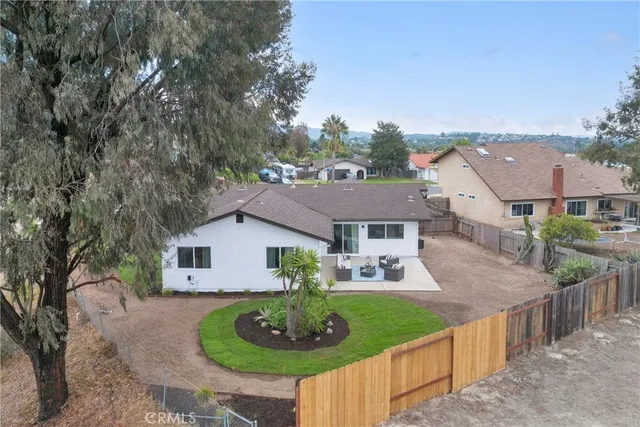 a aerial view of a house with yard and green space