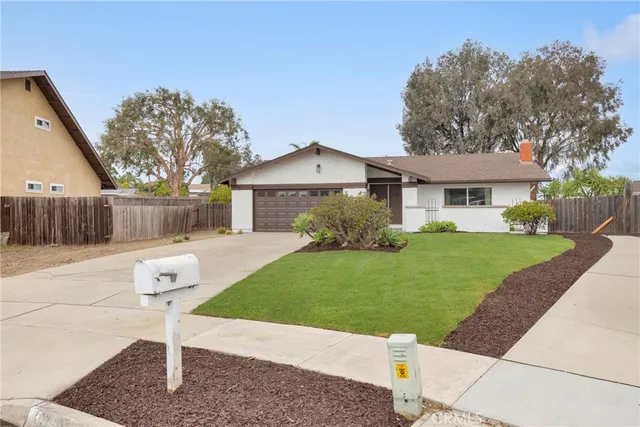 a front view of a house with a yard and a garage