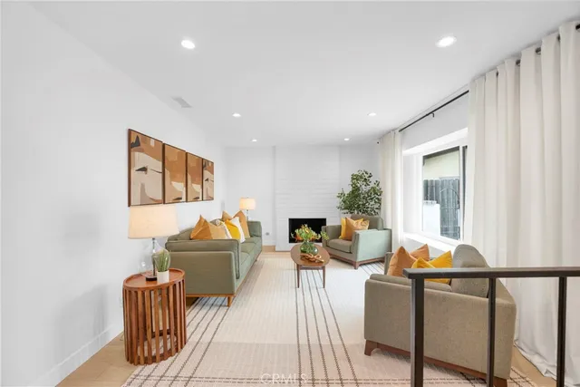 a living room with furniture flowerpot and wooden floor