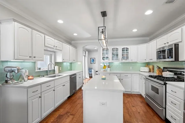 a kitchen with a sink window and cabinets