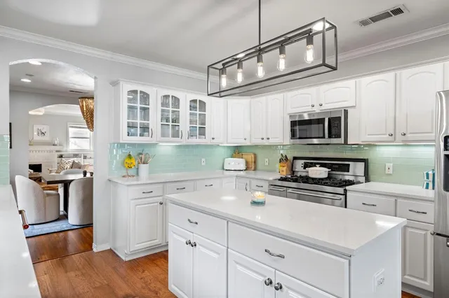 a kitchen with stainless steel appliances a stove microwave and cabinets