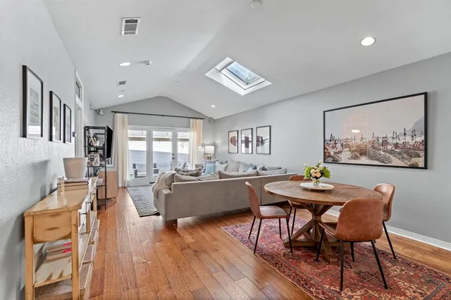 a living room with furniture a desk and chair with wooden floor