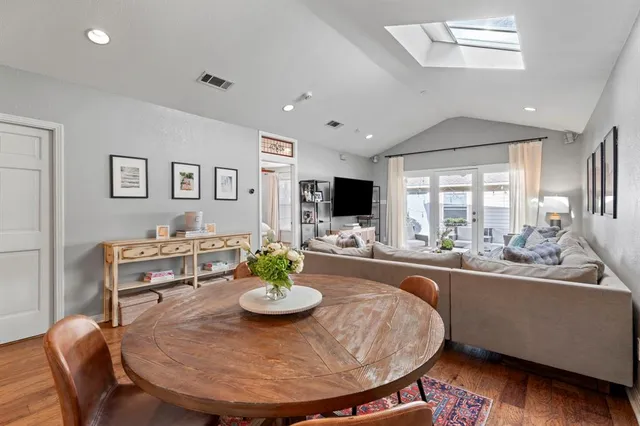a view of a dining room with furniture and a kitchen