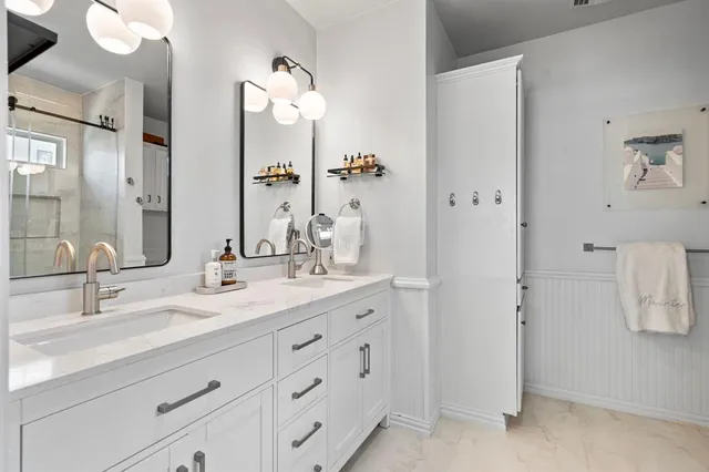 a bathroom with a double vanity sink mirror and double