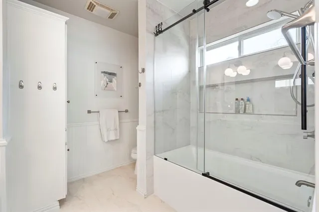 a bathroom with a glass shower door