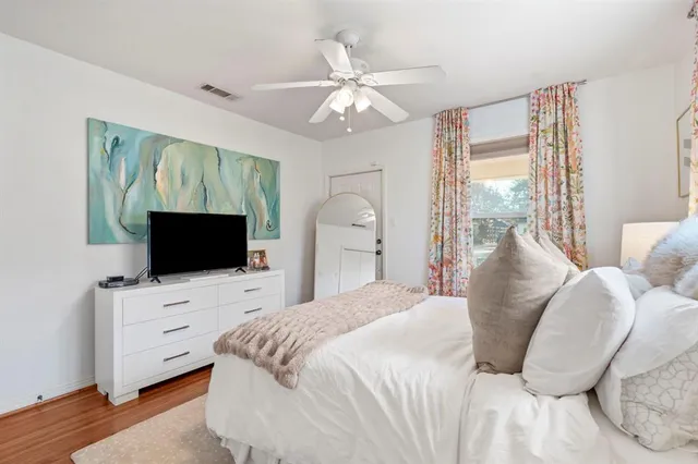 a bedroom with a large bed and a flat screen tv