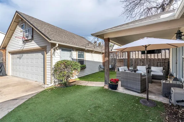 a view of a house with backyard and sitting area