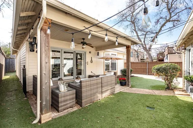 a view of a porch with couches chairs and a yard