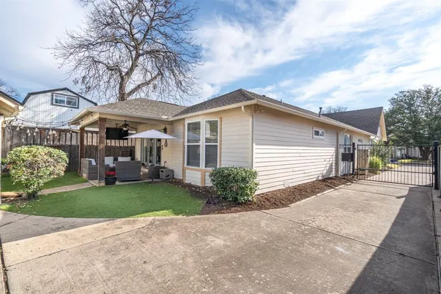 a view of a house with a yard and pathway