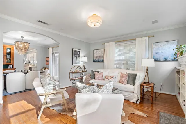 a living room with furniture and a chandelier