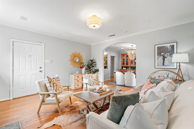 a living room with furniture and wooden floor