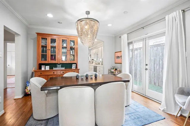a dining room with furniture and wooden floor