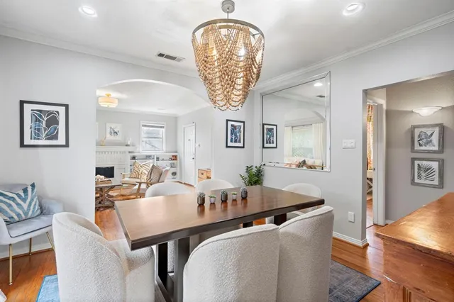 a dining room with furniture and chandelier