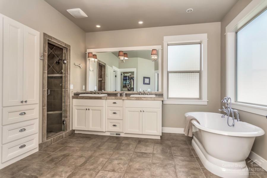 63528 Old Deschutes Road Bend, OR 97701 - Photo 5 of 25 a bathroom with a bathtub sink and mirror