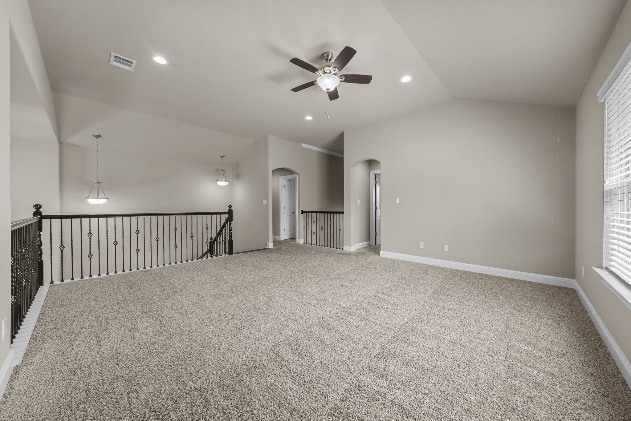 4401 Trinity Woods Street Leander, TX 78641 - Photo 25 of 37 A spacious secondary living area features soft carpeting, a ceiling fan, and abundant recessed lighting.