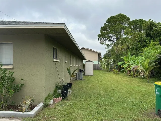 a backyard of a house with table and chairs