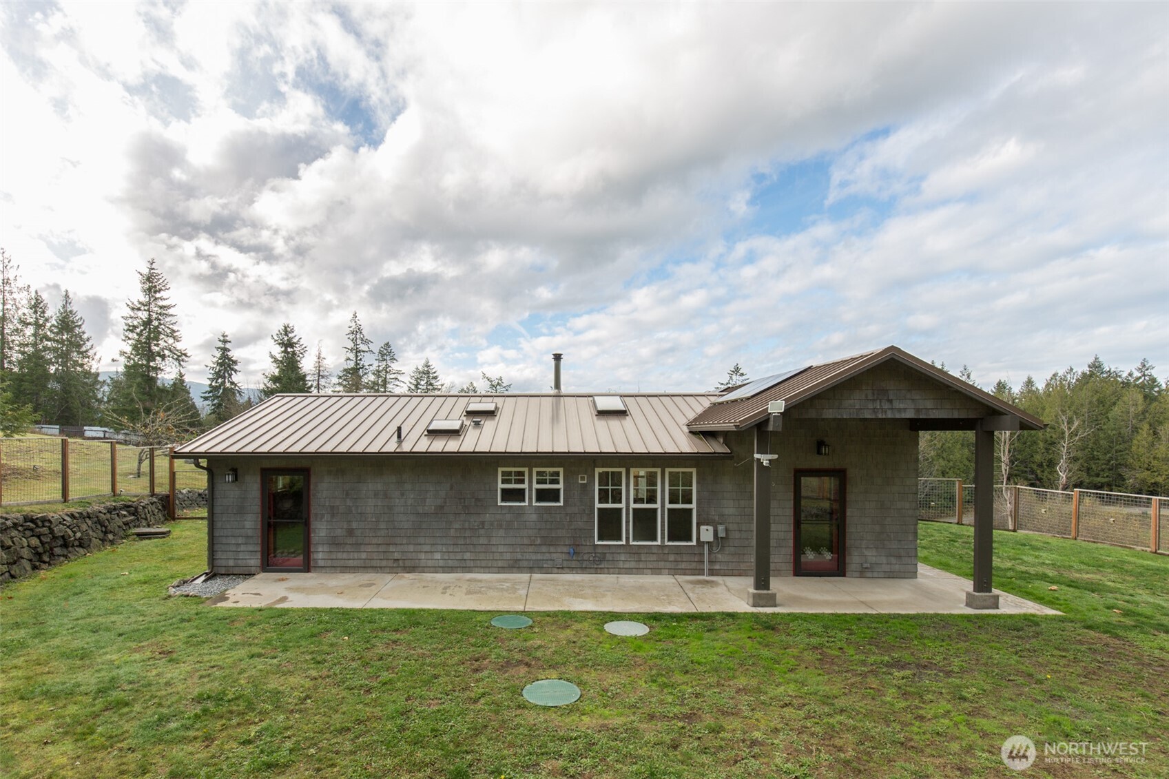 1083 Blyn Springs Road Sequim, WA 98382 - Photo 11 of 40 a front view of a house with a garden and yard
